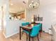 Cozy dining area with modern chandelier, seating for four, and view of the kitchen at 9305 Four Mile Creek Rd, Charlotte, NC 28277