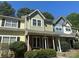 Townhome with brick facade, covered porch, and manicured landscaping at 9305 Four Mile Creek Rd, Charlotte, NC 28277
