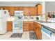 Functional kitchen with stainless steel sink, white appliances, and plenty of cabinet storage at 9305 Four Mile Creek Rd, Charlotte, NC 28277