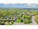 Aerial view shows the condo complex, lush landscaping, mature trees, and traffic at 10967 Harrowfield Rd, Charlotte, NC 28226