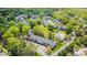 Aerial view showcases lush landscaping, mature trees, parking, and community pool at 10967 Harrowfield Rd, Charlotte, NC 28226