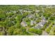 Aerial view of community showing lush landscaping, mature trees, parking, and nearby highway at 10967 Harrowfield Rd, Charlotte, NC 28226