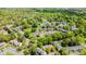 Aerial view featuring lush landscaping, mature trees, parking, and community pool at 10967 Harrowfield Rd, Charlotte, NC 28226