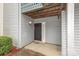 An entrance to a condo unit shows the door and unit number along muted grey siding at 10967 Harrowfield Rd, Charlotte, NC 28226