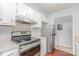 Kitchen view, stainless steel appliances and tile floor near the refrigerator and storage at 10967 Harrowfield Rd, Charlotte, NC 28226