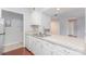 A kitchen featuring white cabinets, a stainless steel sink, and lots of countertop space at 10967 Harrowfield Rd, Charlotte, NC 28226