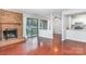Bright living room featuring hardwood floors and sliding glass door to balcony with view to kitchen at 10967 Harrowfield Rd, Charlotte, NC 28226