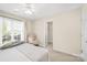 Bright bedroom with a ceiling fan, large window, and cozy decor showcasing a relaxing and inviting atmosphere at 1103 Hillcrest Ridge Dr, Salisbury, NC 28146