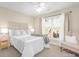 Bright bedroom with a ceiling fan, large window, and cozy decor showcasing a relaxing and inviting atmosphere at 1103 Hillcrest Ridge Dr, Salisbury, NC 28146