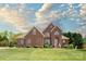 Charming two-story brick home featuring a manicured lawn and professionally landscaped garden beds at 1103 Hillcrest Ridge Dr, Salisbury, NC 28146