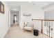 Upstairs hallway features a charming chair, soft natural light, and neutral decor creating an inviting and comfortable space at 1103 Hillcrest Ridge Dr, Salisbury, NC 28146
