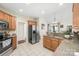 Bright kitchen with granite countertops, tile flooring, and stainless steel appliances at 1103 Hillcrest Ridge Dr, Salisbury, NC 28146