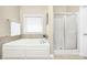 Bright bathroom with a soaking tub, shower and a tile accent wall at 1103 Hillcrest Ridge Dr, Salisbury, NC 28146