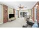 Inviting sunroom features a ceiling fan, brick accent wall, and sliding glass doors to the back patio at 1103 Hillcrest Ridge Dr, Salisbury, NC 28146