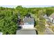 Aerial view of a modern home with a large wooden deck surrounded by mature trees at 1121 N Alexander St, Charlotte, NC 28206