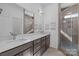 Modern bathroom featuring double sink vanity with solid surface counter and glass enclosed shower at 1121 N Alexander St, Charlotte, NC 28206