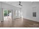 Airy bedroom boasting hardwood floors, a ceiling fan, and sliding glass doors to outdoor deck at 1121 N Alexander St, Charlotte, NC 28206