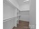 Spacious walk-in closet with ample shelving and hardwood floor at 1121 N Alexander St, Charlotte, NC 28206