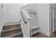 Inviting entryway featuring stylish coat rack with bench, and wood stairs with painted risers and stringers at 1121 N Alexander St, Charlotte, NC 28206