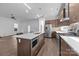 Modern kitchen with stainless steel appliances, a large island, and stylish pendant lighting at 1121 N Alexander St, Charlotte, NC 28206
