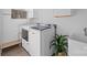 Bright laundry room with new washer and dryer, wooden floors, storage, and large sink at 1121 N Alexander St, Charlotte, NC 28206