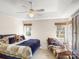 Comfortable bedroom with a ceiling fan, plush bedding, and natural light, creating a relaxing retreat at 115 Keswick Ln, Mooresville, NC 28117