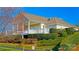 Charming exterior view of community home surrounded by lush landscaping, mature trees and a well-manicured lawn at 115 Keswick Ln, Mooresville, NC 28117