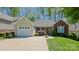 Charming single-story home with a well-maintained front yard, attached garage, and inviting entrance at 115 Keswick Ln, Mooresville, NC 28117