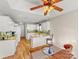 Open kitchen with an eating area, featuring granite countertops, white cabinets, tiled backsplash, and wooden floors at 115 Keswick Ln, Mooresville, NC 28117