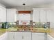 Well-lit kitchen with granite countertops, white cabinetry, tiled backsplash, and stainless steel appliances at 115 Keswick Ln, Mooresville, NC 28117