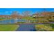 Picturesque view of a pond with a fountain, surrounded by mature trees and lush landscaping at 115 Keswick Ln, Mooresville, NC 28117