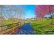 Scenic walking path lined with trees and lush green grass, perfect for an enjoyable stroll at 115 Keswick Ln, Mooresville, NC 28117