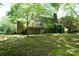Spacious backyard with wooden deck and stairs, green grass, and mature trees offer private setting at 1174 Orchard Dr, Fort Mill, SC 29715