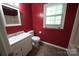 Bathroom with single sink vanity, mirror, toilet, tiled floors and a window at 1174 Orchard Dr, Fort Mill, SC 29715