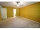 Large bedroom with a ceiling fan, carpet, natural light and view into the bathroom at 1174 Orchard Dr, Fort Mill, SC 29715