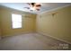 A bright bedroom featuring carpet flooring, neutral walls, and a ceiling fan with overhead lighting at 1174 Orchard Dr, Fort Mill, SC 29715