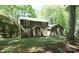 Charming two-story home with a well-manicured lawn, mature trees, and quaint red shutters, blending comfort and curb appeal at 1174 Orchard Dr, Fort Mill, SC 29715