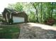 Home's exterior with attached two-car garage and private driveway surrounded by lush greenery at 1174 Orchard Dr, Fort Mill, SC 29715