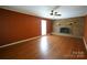 Spacious living room with hardwood floors, brick fireplace, ceiling fan and natural light from window at 1174 Orchard Dr, Fort Mill, SC 29715