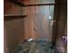 Compact laundry room with shelves, washer hookups, and stone-look flooring at 1217 Stony Point Rd, Kings Mountain, NC 28086