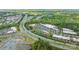 Wide aerial view of the community featuring easy highway access, shopping centers, and wooded areas at 12357 Copper Mountain Blvd, Charlotte, NC 28277