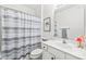 Cozy bathroom featuring a shower with a striped curtain and a single vanity with countertop decor at 12357 Copper Mountain Blvd, Charlotte, NC 28277