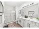 Clean bathroom featuring a double vanity, spacious mirror and walk in shower with glass door at 12357 Copper Mountain Blvd, Charlotte, NC 28277