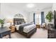 Comfortable bedroom with a queen bed, a window with natural light, and a desk for a workspace at 12357 Copper Mountain Blvd, Charlotte, NC 28277