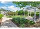 Serene community area with walking path, well-manicured lawn, pergola, picnic tables, and lush trees at 12357 Copper Mountain Blvd, Charlotte, NC 28277