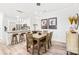 Dining area featuring modern lighting, seating for six, and an open concept to the kitchen at 12357 Copper Mountain Blvd, Charlotte, NC 28277