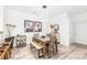 Dining room with modern lighting, seating for six, and access to the kitchen and living areas at 12357 Copper Mountain Blvd, Charlotte, NC 28277