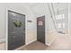 Hallway with two entry doors, fire safety equipment, neutral paint, and access to an exterior exit at 12357 Copper Mountain Blvd, Charlotte, NC 28277