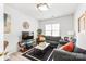 Comfortable living room with a gray sofa, decorative pillows, a TV, and plenty of seating at 12357 Copper Mountain Blvd, Charlotte, NC 28277