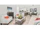 Bright living room with modern decor and an open floor plan leading to the kitchen at 12357 Copper Mountain Blvd, Charlotte, NC 28277